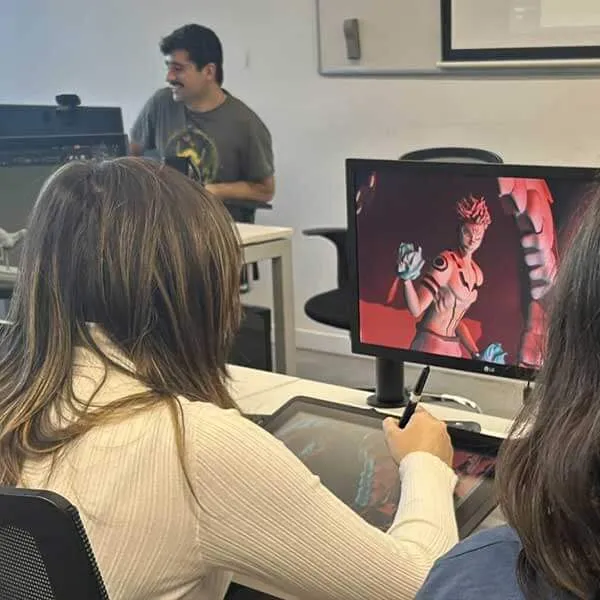 Students sculpt using ZBrush while the instructor demonstrates on the projector