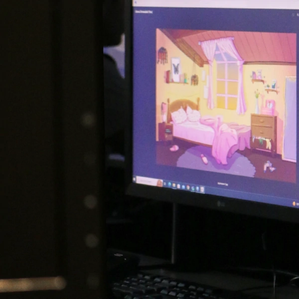 two screens show the 3D model and environment created by a student for a project