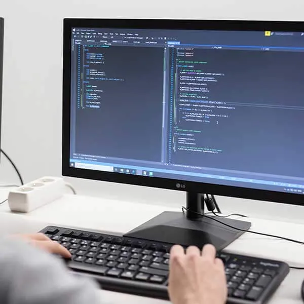 A student writes code on their computer