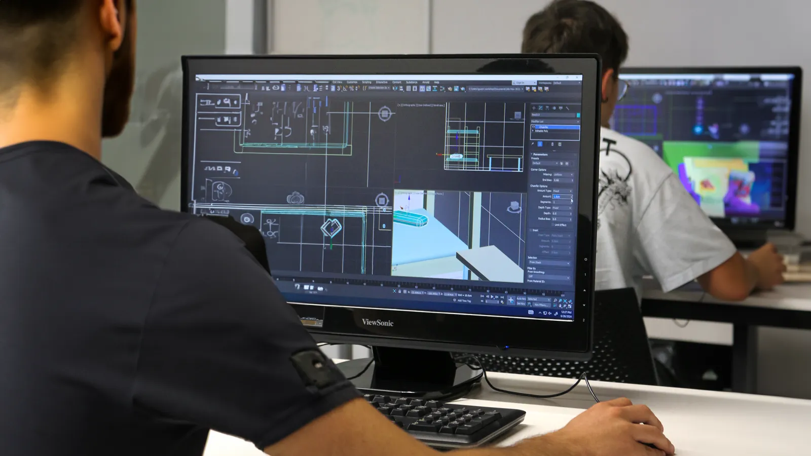 Two students uswing a 3D modeling software