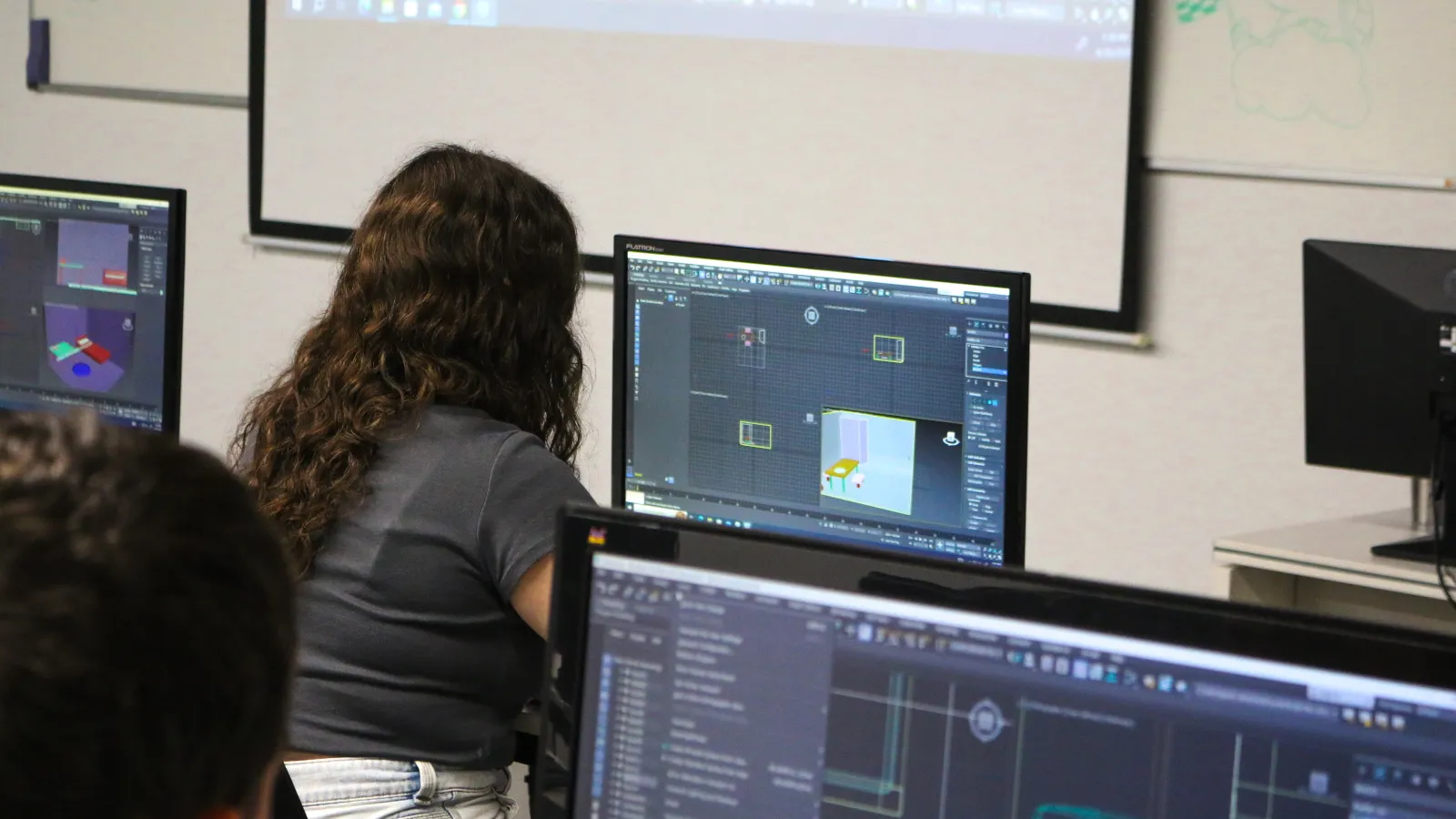 A girl using the adquired skills during the class to work on her 3D animation project