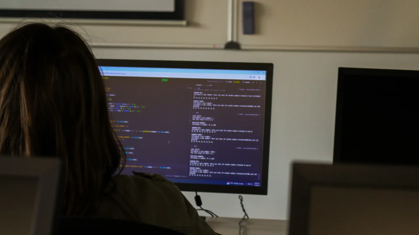 Student works on her coding project, the screen shows a piece of code written in c++