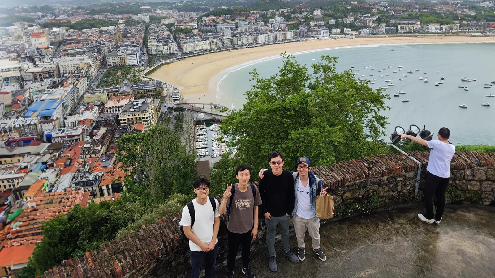 Three Singapore students pose for a group picture at La Concha beach, in Donosti