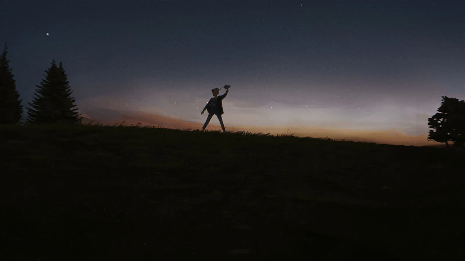 A young girl stands in an esplanade at nightfall, playing with a rocket in her hand