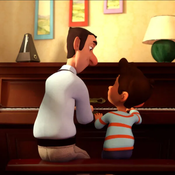 The backs of a man in a white shirt and a boy in a blue and red striped t-shirt as they sit at a brown wooden upright piano