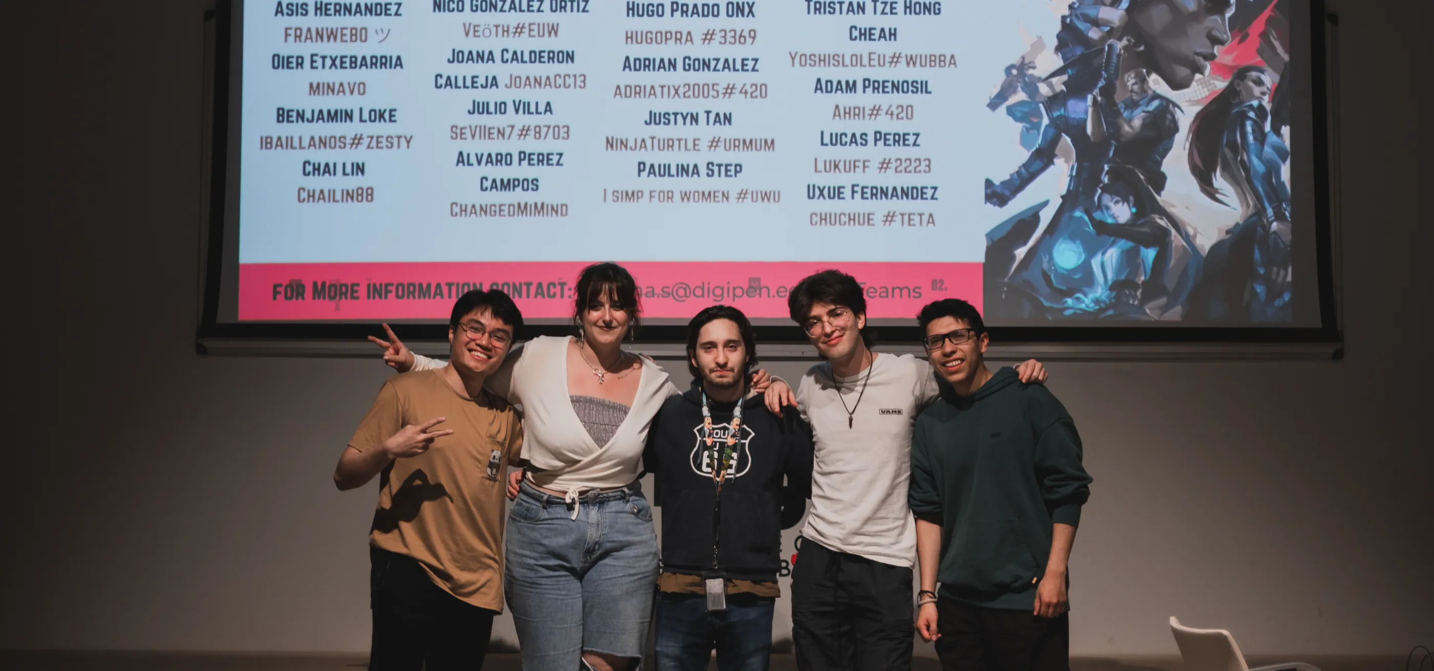 The winners of the competition pose for a picture, with the names of all the participants they beat behind