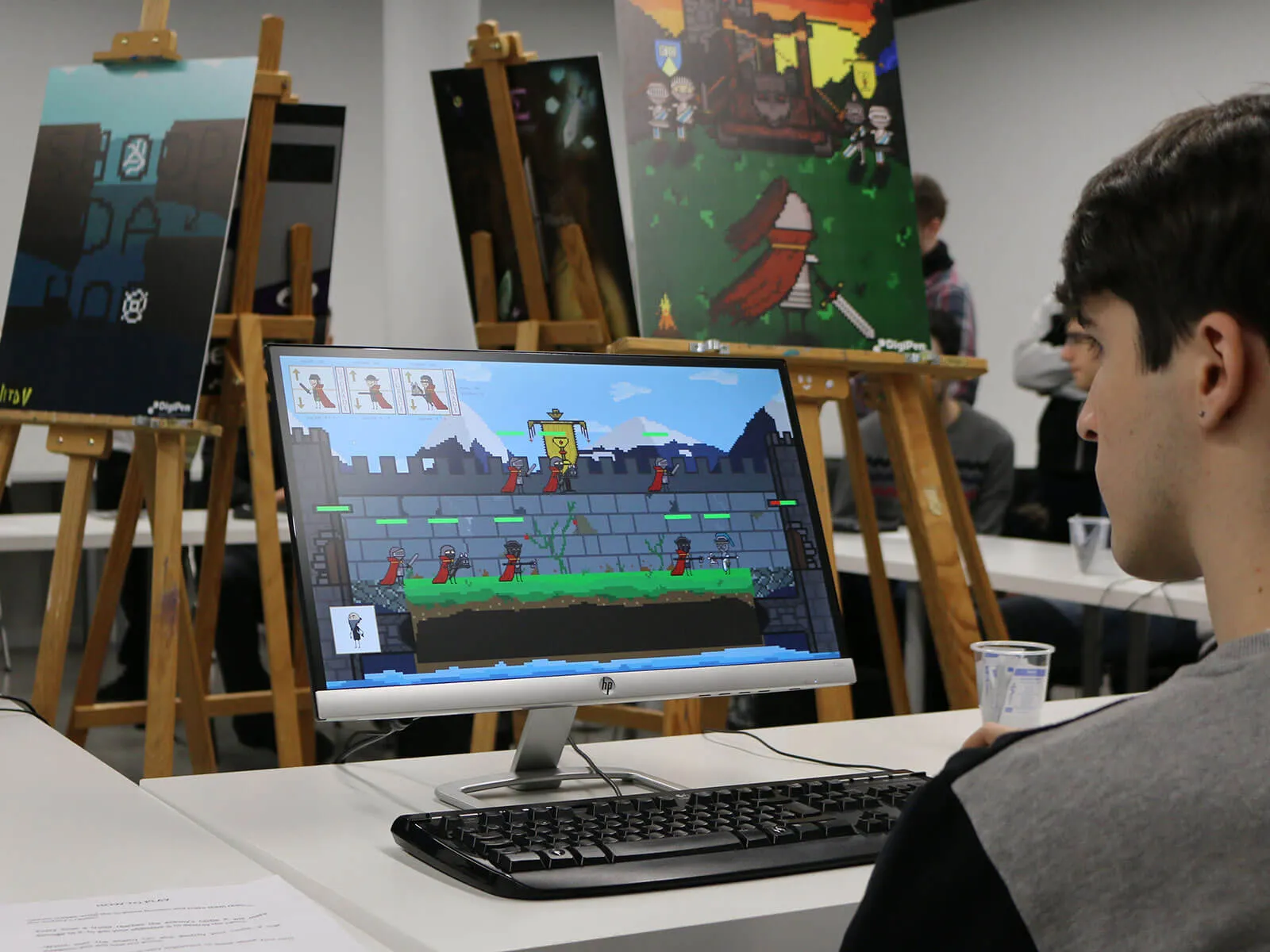 A Bilbao student sits in a computer lab in front of a computer.