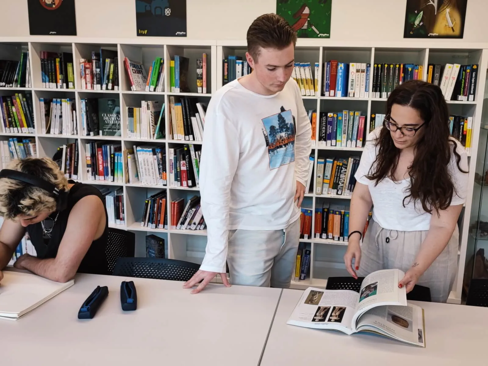 The librarian is showing some resources to a student.