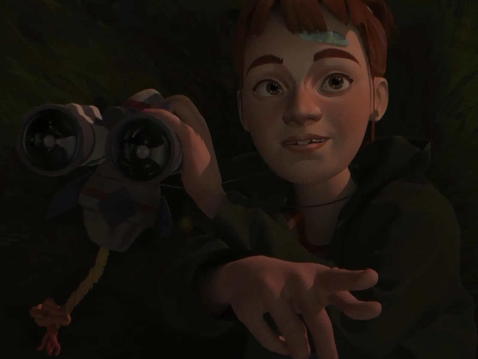 A girl lies in the grass, clutching binoculars.