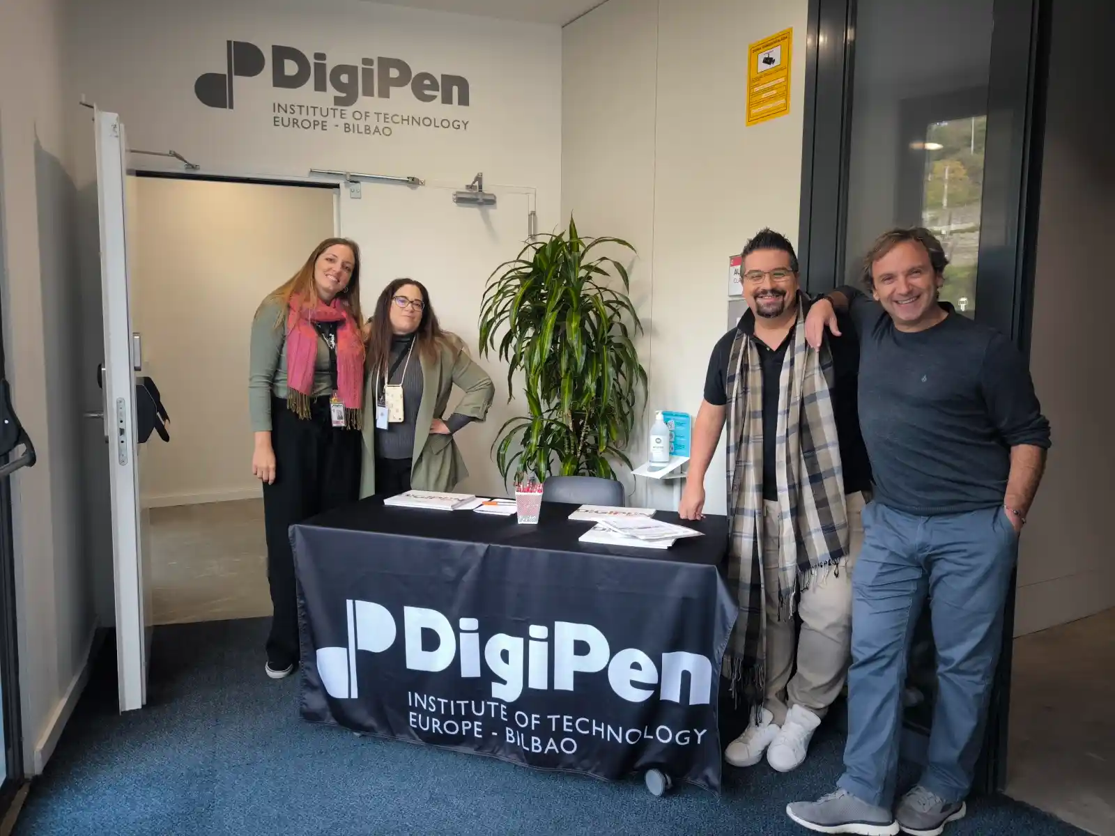 Staff members welcoming visitors at the entrance of DigiPen Europe-Bilbao during last year Open House event