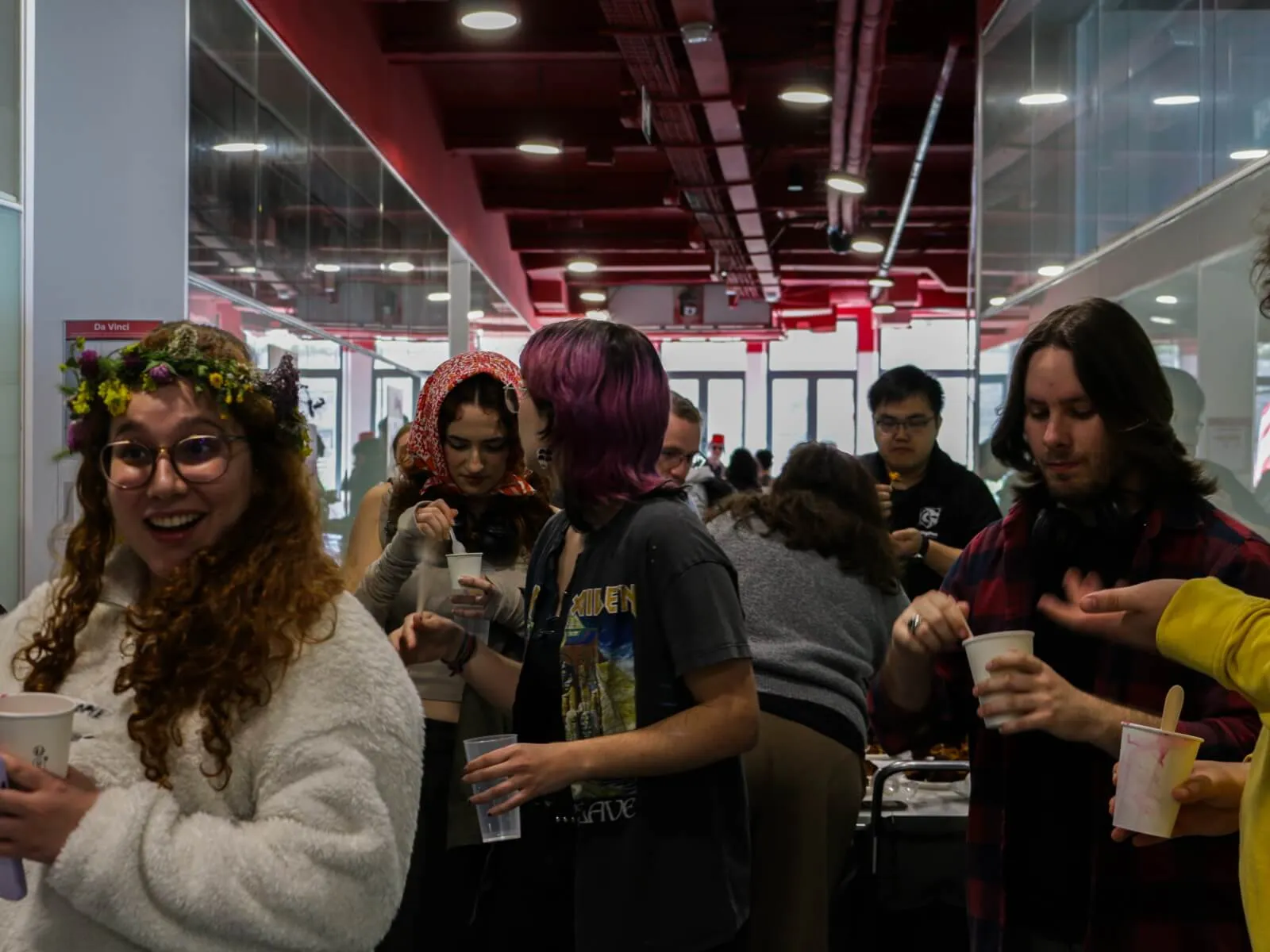 A diverse group of students gathered with delicious food, engaging in conversation and enjoying each other's company