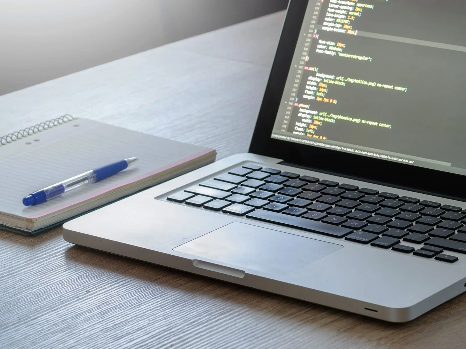 A laptop, a notebook, and a pen ready above; materials prepared for note-taking and starting learning Computer Science