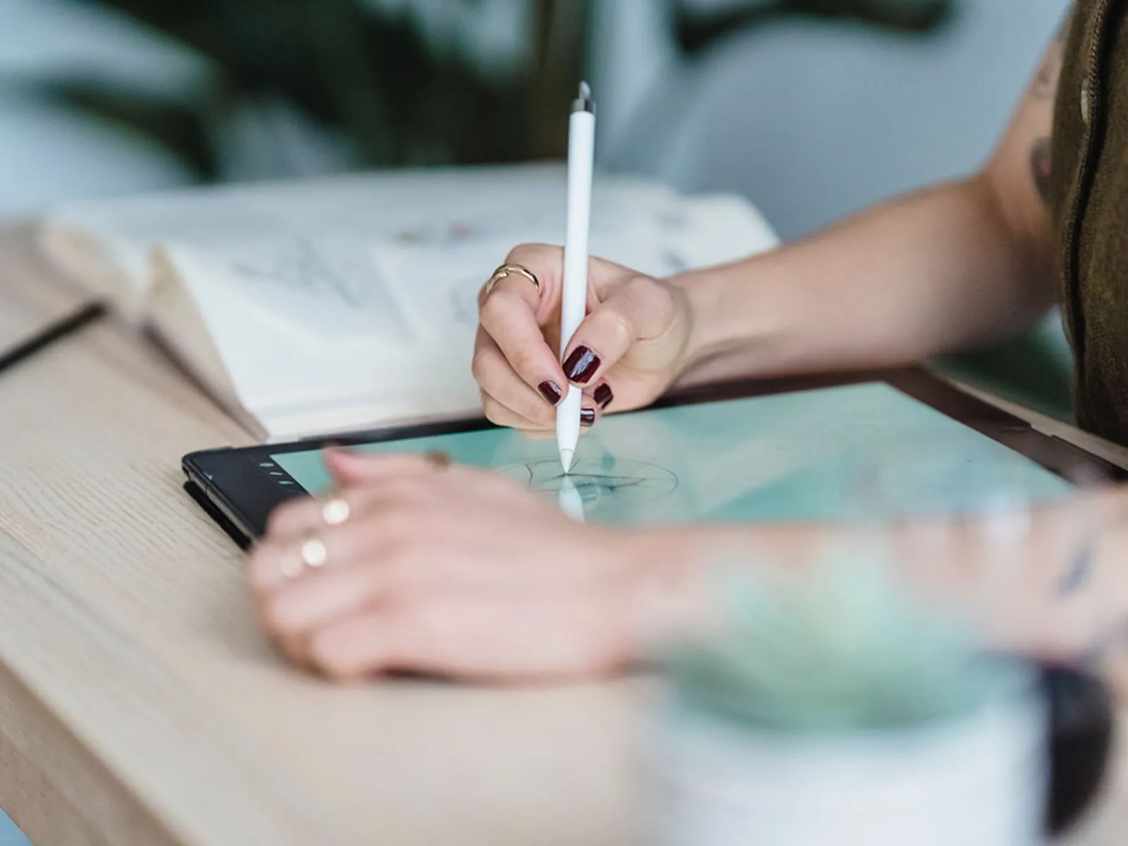 A student sketches on a tablet.