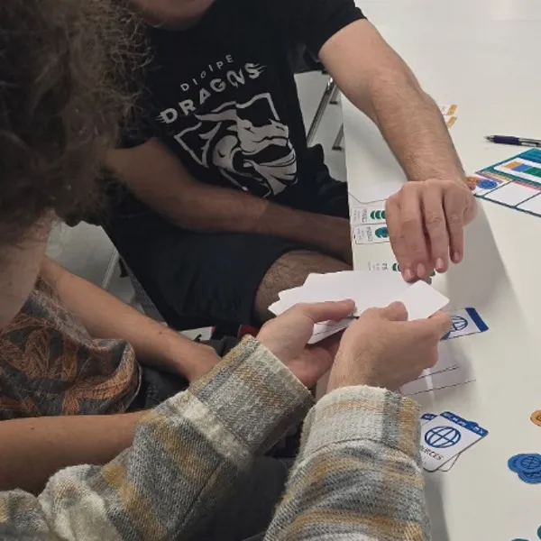 Four students playing ‘System Overload’ with cards in a DigiPen Europe-Bilbao’s table.