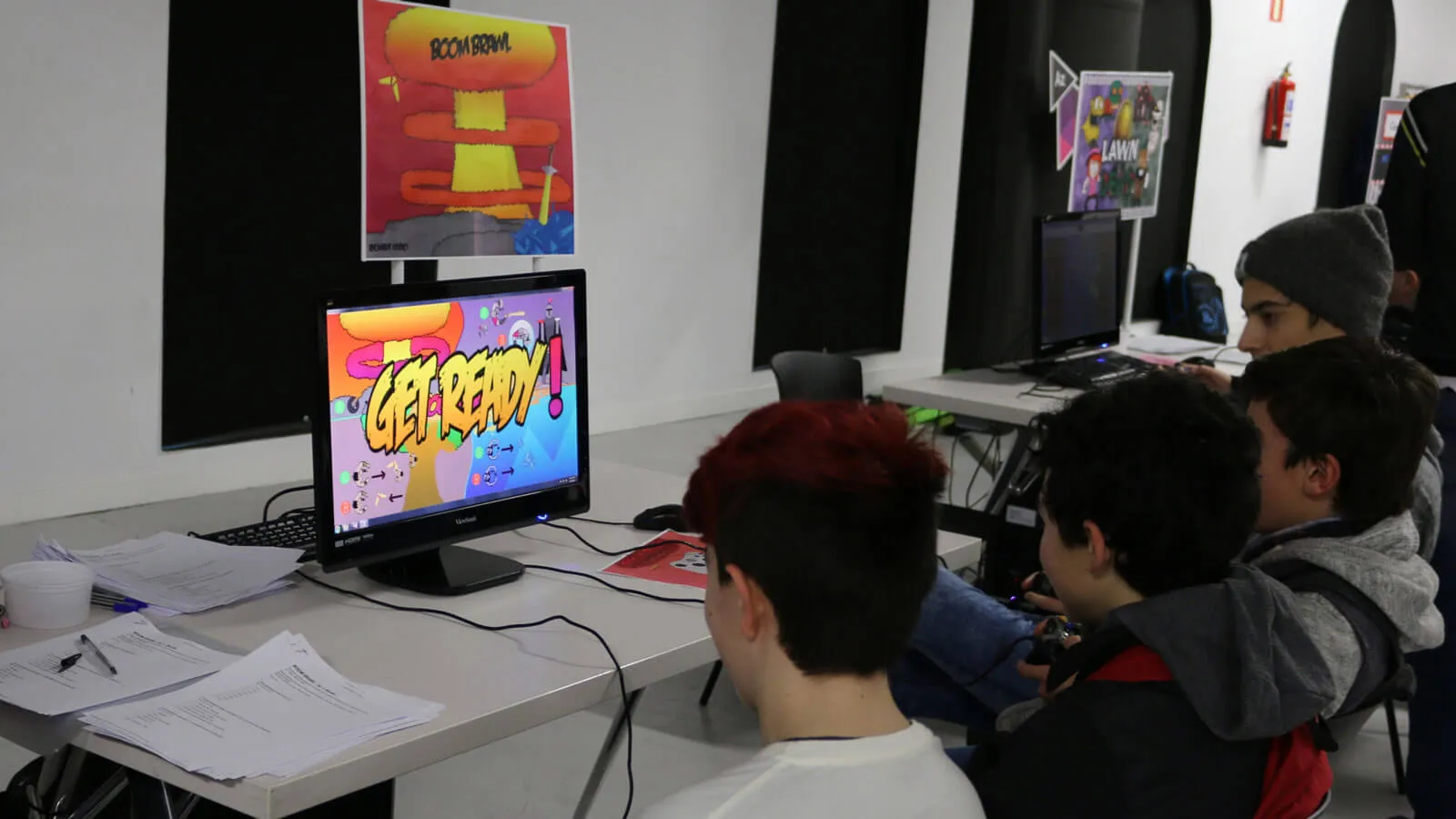 Multiple students play a multiplayer game on a single screen.