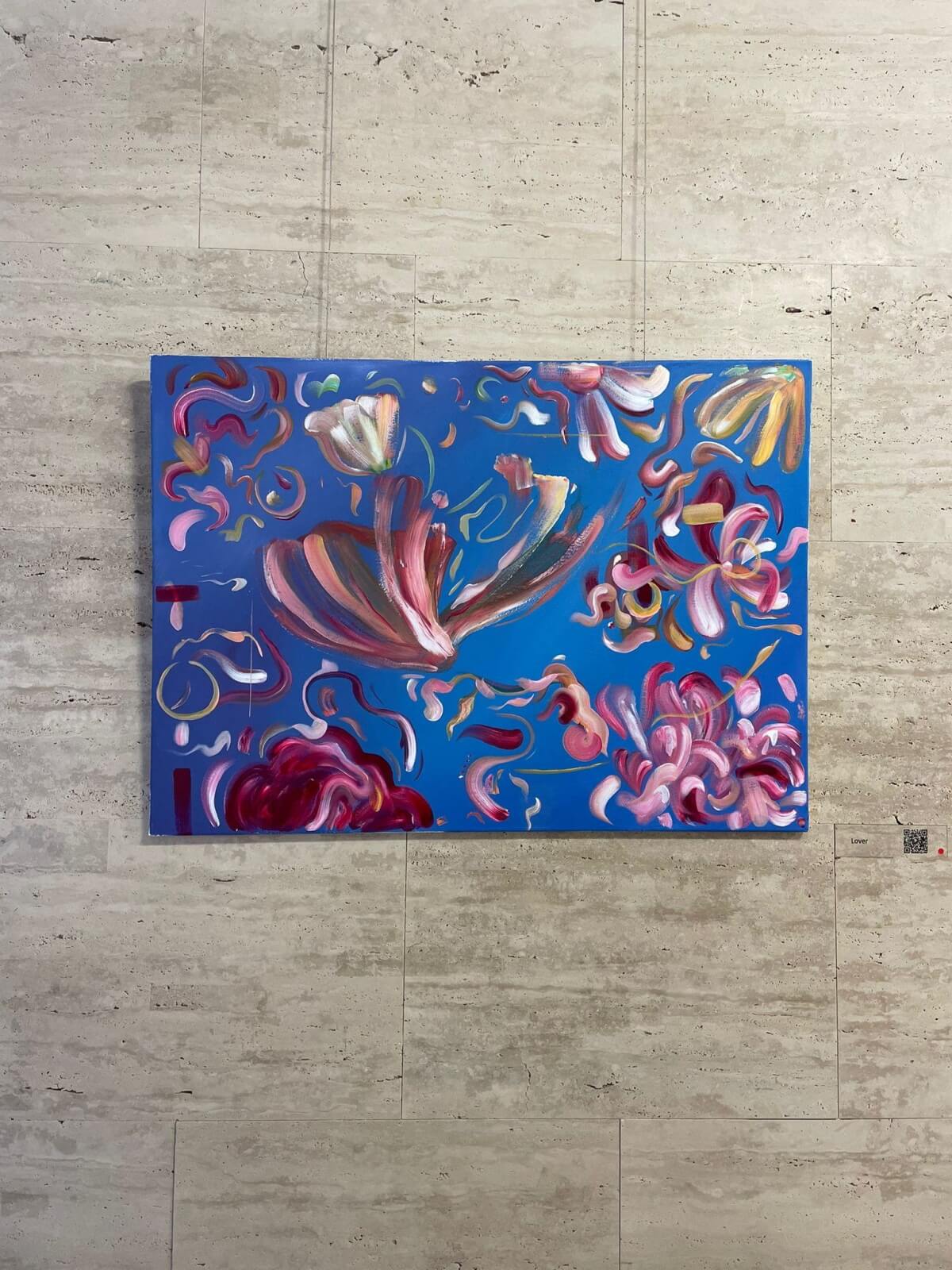 Abstract painting with floral elements on a blue background.