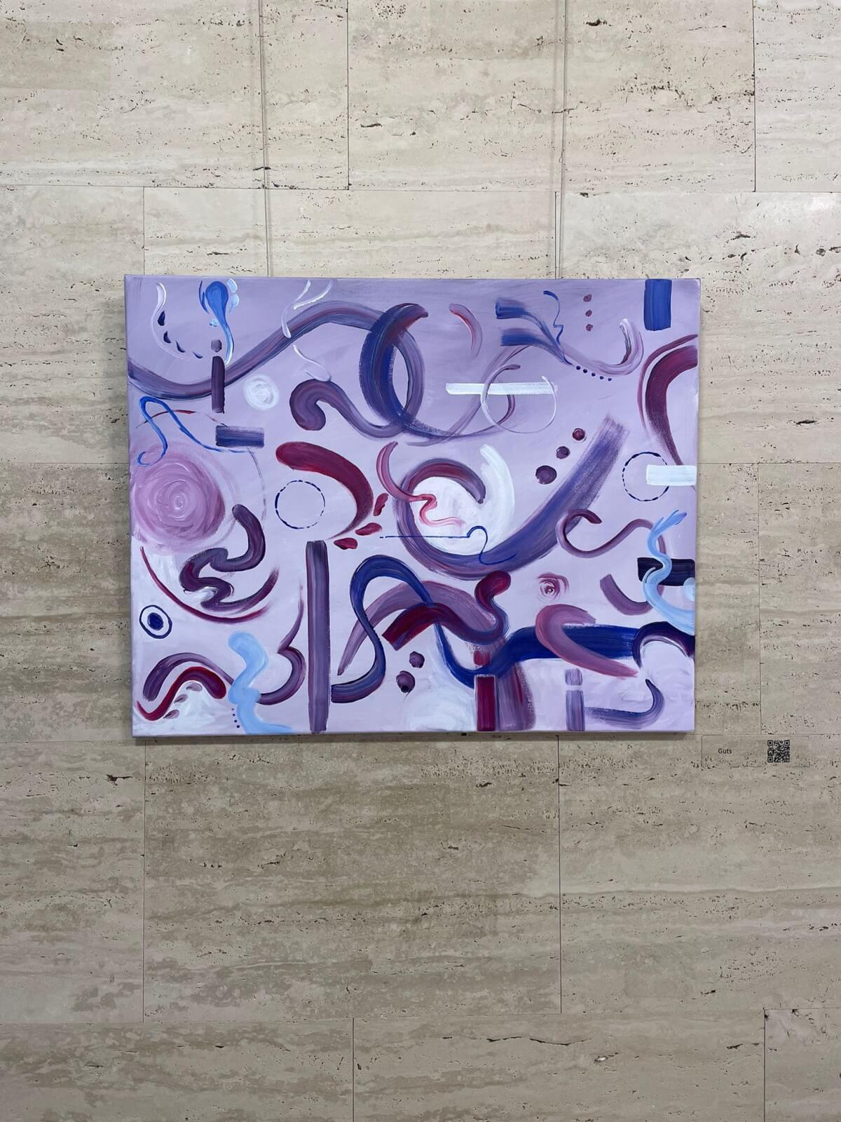 Abstract painting with purple and blue swirling shapes on a stone wall