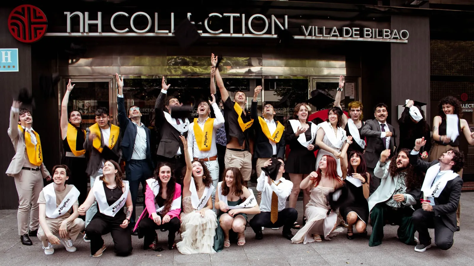 Thrilled graduates throw their caps up.