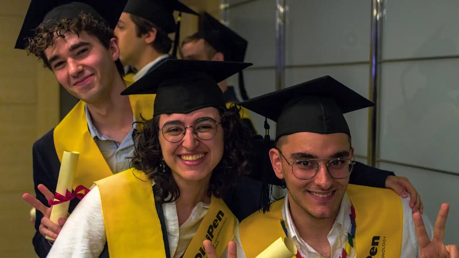 RTIS graduates smiling after receiving their diploma.