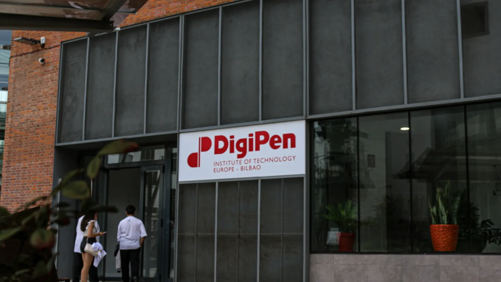 Entrance of DigiPen Europe-Bilbao with the new students entering through the gate.