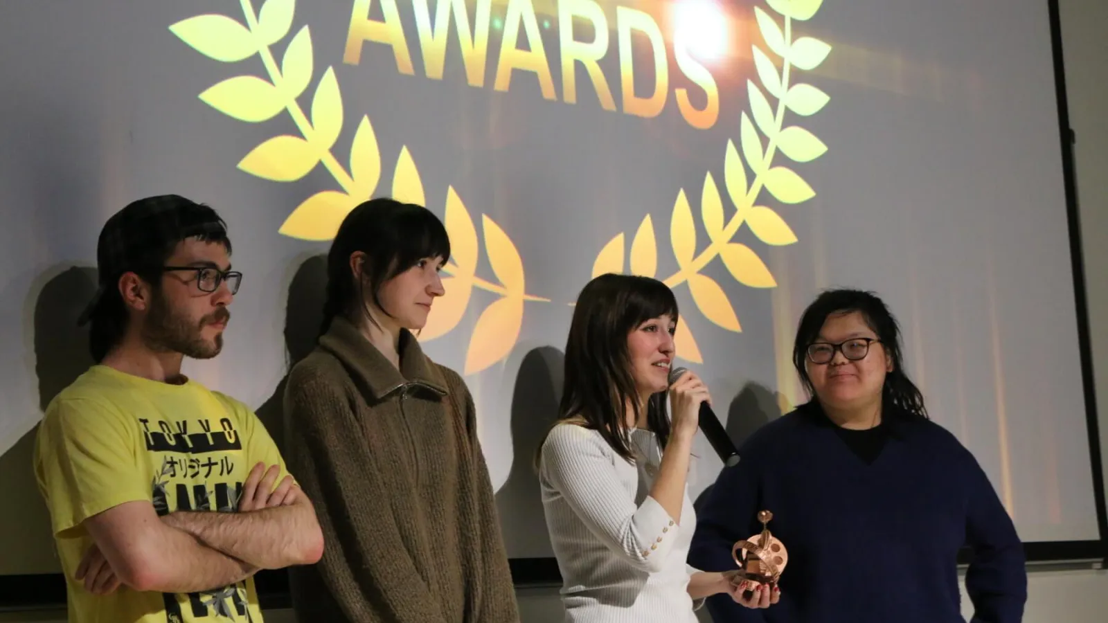 A student film team speaks during the awards show after receiving an award.