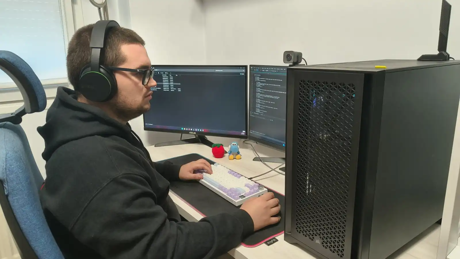 Portrait of Mikel Sertutxa, RTIS graduate, sitting in front of his workplace as a programmer for Bohemia Interactive.