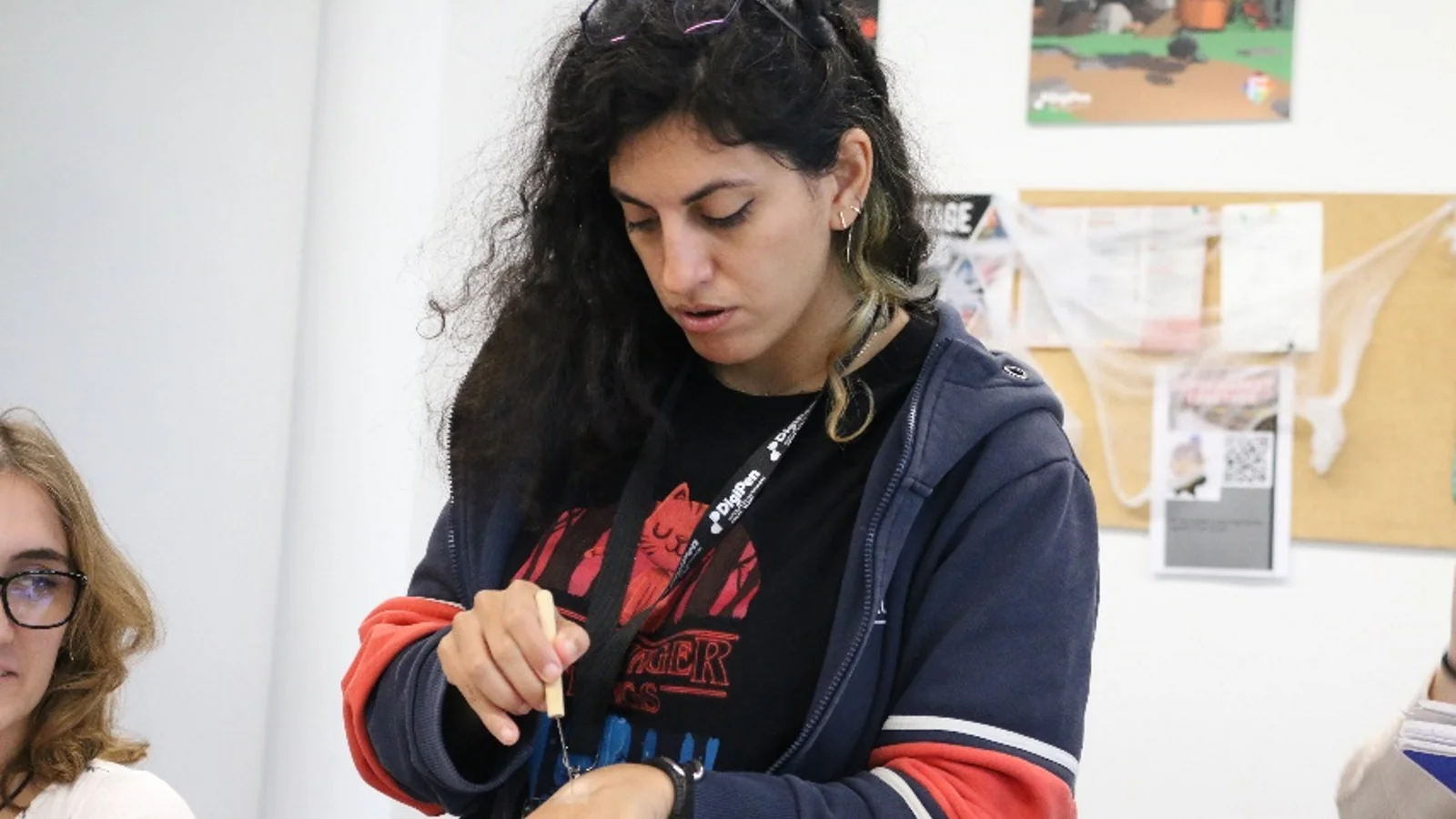 Professor Laura Choueri demonstrates special effects makeup techniques to students at the Halloween Makeup Workshop.